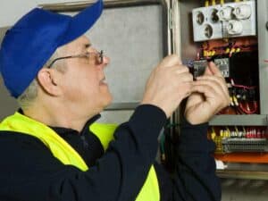 Man Inspecting Electrical Circuitry