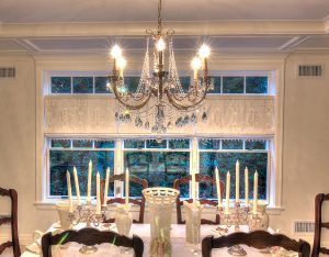 crystal chandelier over a dining room table.