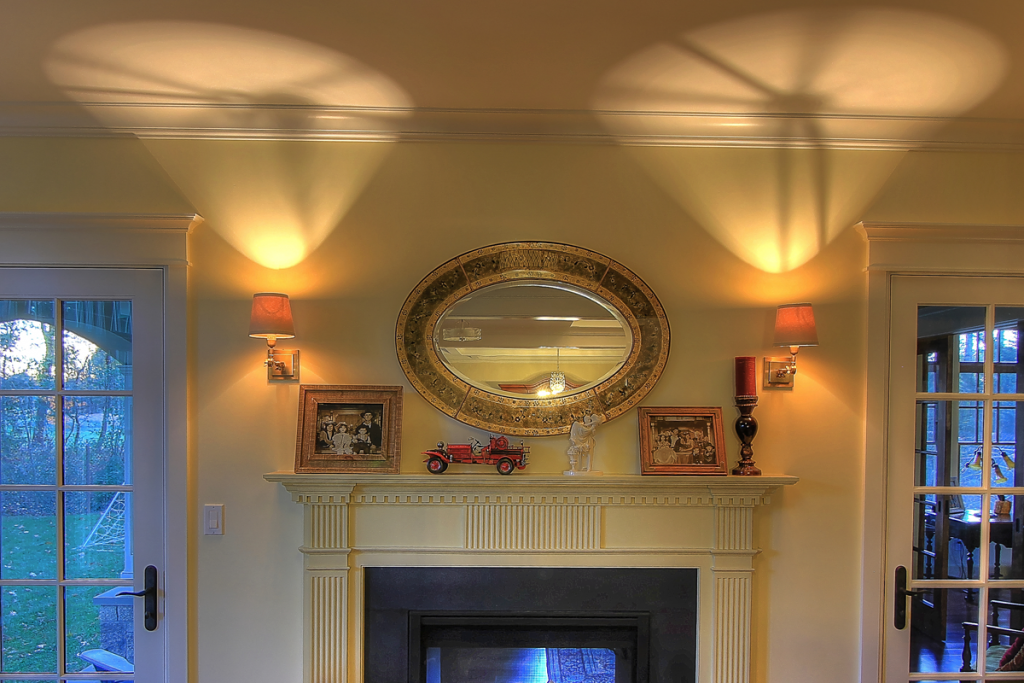 traditional fireplace with updated sconces.