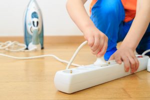 child playing with surge protector