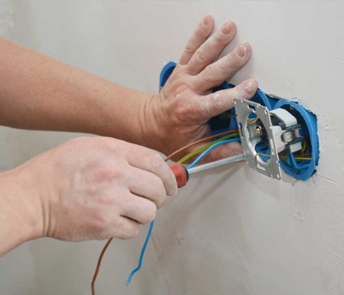 electrician installing wall switch.
